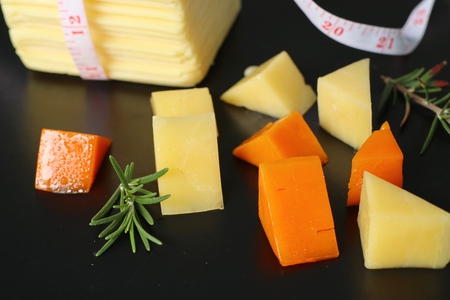 Piece and slices of cheeseの写真素材