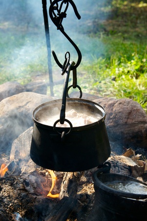 Preparing food on campfireの写真素材