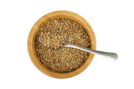 wood bowl and steel spoon with lentil isolated on whiteの写真素材