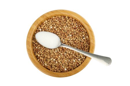wood bowl with raw buckwheat and spoon with salt isolated on whiteの写真素材