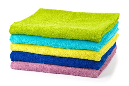 stack of colored bathroom towels isolated on whiteの写真素材