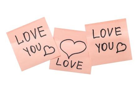 three pink sticky notes with hearts isolated on whiteの写真素材