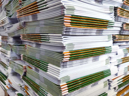 Lot of books stacked in layers in huge endless wall of knowledge. Industrial printing house. Book...