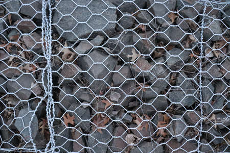 metal mesh on the ground in the park, close-up.の写真素材