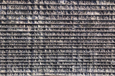 abstract background of a metal profile of a staircase in the snowの写真素材