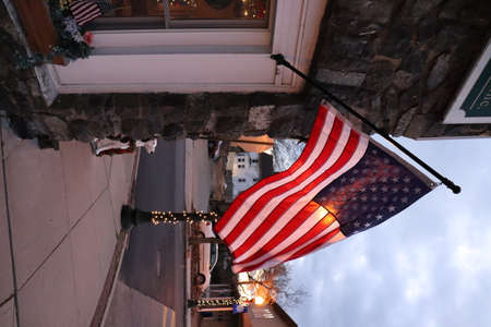 The flag of the United States of America hangs from the window of a restaurant in New York City.の写真素材