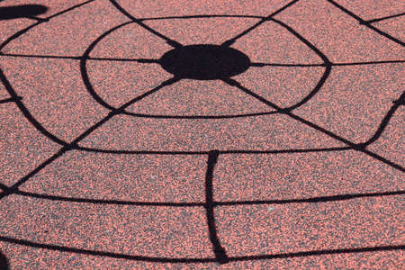 A closeup shot of a black hole on a red surfaceの写真素材