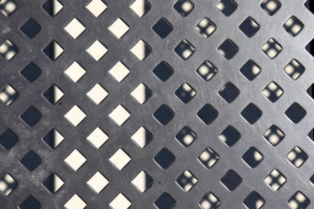 abstract background of metal grid with holes. close-up.の写真素材