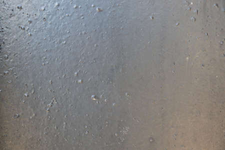 Close-up view of water drops on the wet glass surface.の写真素材