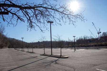 Empty parking lot in a city park with a blue sky in the backgroundの写真素材