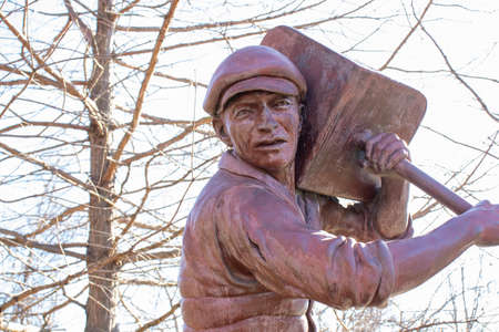 Bronze sculpture of a worker with a shovel.の写真素材
