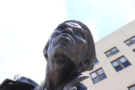 Statue of a man looking up at the skyの写真素材