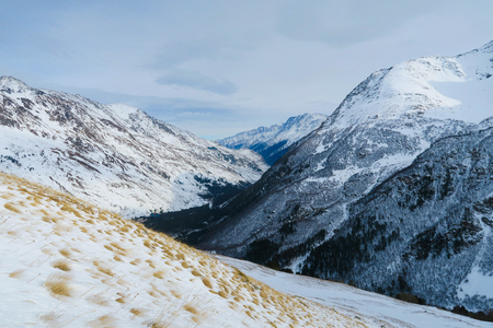 Mountain range of Caucasian Mountains in the clouds blue sky. Syltran gorgeの写真素材