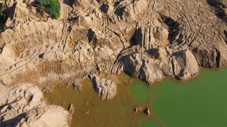 Flooded sand quarry. Place where dirt bikes ride and leave traces. Landscape for extreme...