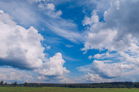 Picturesque summer landscape with white fluffy summer clouds on blue marvelous sky view background....