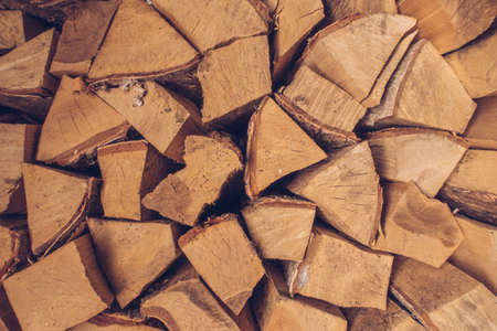 Wall of firewood. Prepared pile of dry chopped firewood logs stock photographyの写真素材