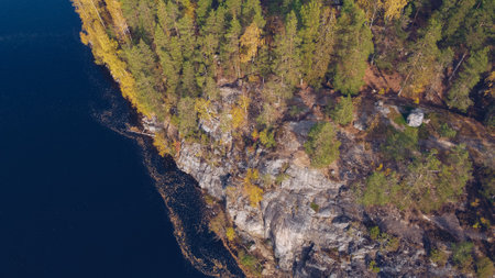 Aerial drone view on Yastrebinoe lake and cliffs. Beautiful season landscape with a lake or river water and larch trees. Russia, Karelia. Stock photoの写真素材