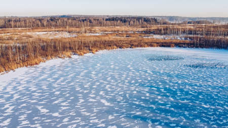 Frozen winter lake ice aerial view. Beautiful clear blue ice stock phototography from bird's eye view. Selective focus, blurred background.の写真素材
