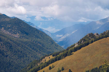 Picturesque marvelous view in the mountains. Amazing mountain range valley scenic landscape among clouds and colordul hills. Autumn season in the mountains stock photoの写真素材