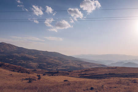 Armenia mountain autumn view. Dry land mountain range and steppe picturesque landscape view with blue sky. stock photo.の写真素材