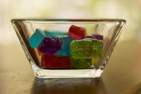 colorful candies in candy on wooden table cafeの写真素材