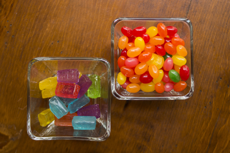colorful candies in candy on wooden table cafeの写真素材