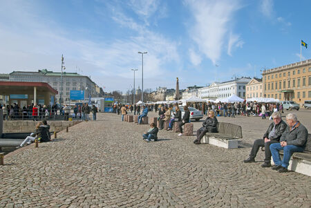 People resting along the quay. Market Square. Helsinki. Finland. April 16th, 2011のeditorial素材