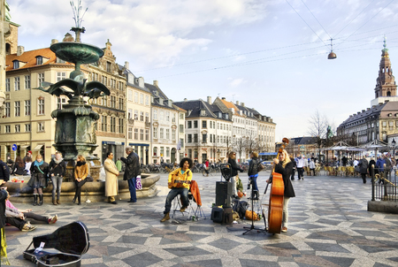 COPENHAGEN, DENMARK - APRIL 13, 2010: Musicians near the Fountain Stork. It is a traditional meeting point. Located on Amagertorv and near car free zone Strogetのeditorial素材