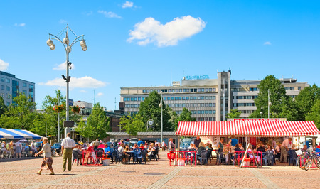 LAHTI, FINLAND - JULY 17, 2010: People rest and eat in cafes on Market Square in the center of Lahti. On the background is Alex Park Hotelのeditorial素材