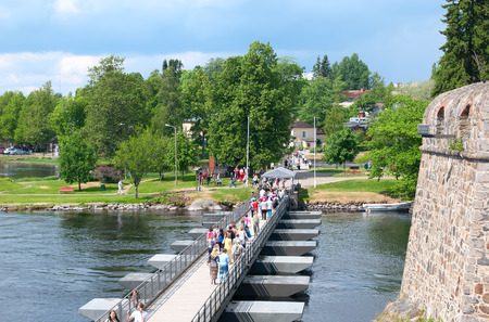 SAVONLINNA, FINLAND - JUNE 8, 2013: Floating bridge between Olavinlinna Castle and Tallisaari (Stable Island). There were castle horse stables centuries ago. Now it is a popular park with sculpturesのeditorial素材
