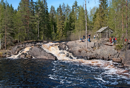 RUSKEALA, KARELIA, RUSSIA - MAY 14, 2016: Excursion group near Ahvenkoski Waterfall on Tohmajoki River. It is one of the four plain waterfalls (Ruskeala Waterfalls) in Sortavala District of Kareliaのeditorial素材