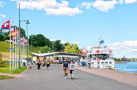 LAPPEENRANTA, FINLAND - JUNE 15, 2016: People walk near boats on the bank of Saimaa Lake in summerのeditorial素材