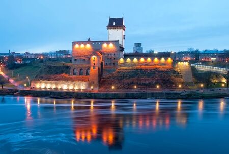 NARVA, ESTONIA - JANUARY 1, 2017: Hermann Castle Museum on the bank of The Narva (Narova) River. On the right side is The Bridge of Friendship between Estonia and Russia. View from Russian territoryのeditorial素材