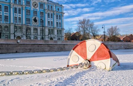 SAINT-PETERSBURG, RUSSIA, FEBRUARY 10, 2017: View of the frozen Neva River with float of The Cruiser Aurora near Petrogradskaya Embankment. On the background is Nakhimovskoye Naval Collegeのeditorial素材