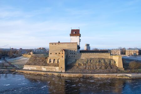 NARVA, ESTONIA - JANUARY 3, 2017: Hermann Castle Museum on the bank of The Narva (Narova) River. On the right side is The Bridge of Friendship between Estonia and Russia. View from Russian territoryのeditorial素材