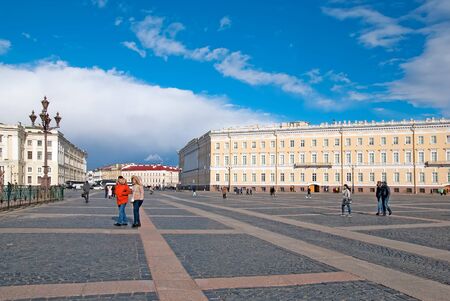 SAINT-PETERSBURG, RUSSIA, MARCH 29, 2017: People go near The Alexander Column on The Palace Square. On the background is The General Staff Building, part of The State Hermitageのeditorial素材