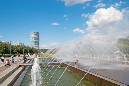 SAINT - PETERSBURG, RUSSIA - AUGUST 16, 2017: Children and adults are resting near the fountain with a rainbow in the 300 years. Petersburg Anniversary Parkのeditorial素材