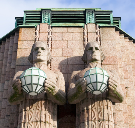 Two figures holding lanterns. Sculptures of Central Railway Station. Helsinki. Finlandのeditorial素材