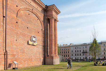 SAINT-PETERSBURG, RUSSIA - JUNE 11, 2018: New Holland Island. People rest on the grass and take pictures of Peace on Earth! installation by Gyula Varnai, Hungarian artistのeditorial素材