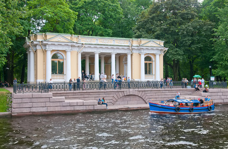 SAINT-PETERSBURG, RUSSIA - JUNE 23, 2018: People in a small boat sail on Moyka River near Mikhailovsky Garden and Rossi Pavilionのeditorial素材