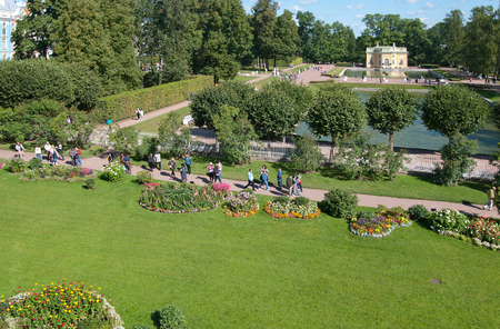 TSARSKOYE SELO, SAINT-PETERSBURG, RUSSIA - AUGUST 22, 2018: People in The Freylinsky garden (Maids of Honor Garden). On the background is the Upper Bathhouse Pavilion and the Mirror Pondのeditorial素材