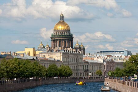 SAINT-PETERSBURG, RUSSIA - JULY 7, 2019: People on excursion boat sail on The Moika River. On the background is Saint Isaac Cathedralのeditorial素材