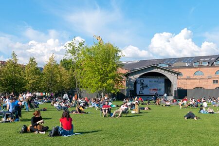 SAINT-PETERSBURG, RUSSIA - JULY 7, 2019: People rest on the lawn of The New Holland Island. It is an artificial island in the center of the city. Was created in 1719のeditorial素材