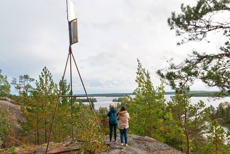 Kilpola Island. Lakhdenpokhsky District. Republic of Karelia. Russia - September 22, 2018: People take pictures of Ladoga Lake from Rullalahdenvuori Rock in autumnのeditorial素材