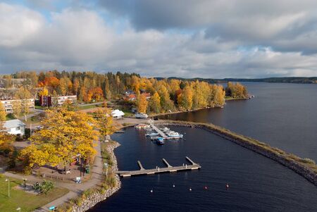 Puumala, FinlandâOctober 5, 2019: Top view of The Saimaa Lake with boats on the pier and residential buildings in autumn. Puumala Municipality. Southern Savonia (Savo) Regionのeditorial素材