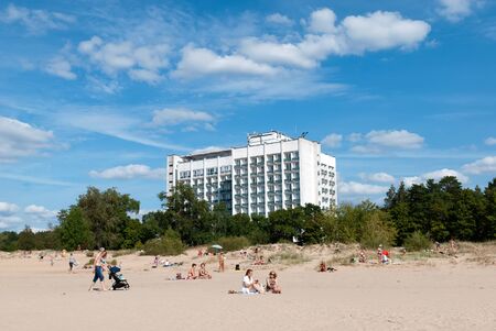 Sestroretsk, Saint-Petersburg, Russia â August 18, 2019: People on the sand beach of The Gulf of Finland near the main building of The Sestroretsk Kurort Sanatoriumのeditorial素材