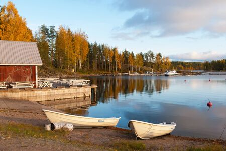 Puumala, FinlandâOctober 5, 2019: Boats on the waterside of Saimaa Lake on the territory of Sahanlahti Resort. Puumala Municipality. Southern Savonia (Savo) Regionのeditorial素材