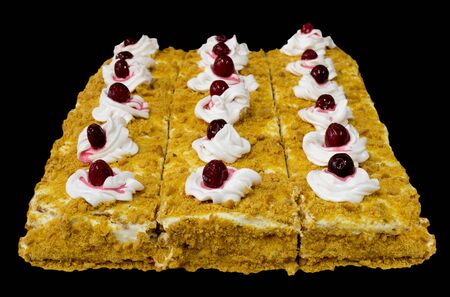 Some homemade puff pastry cakes with cream and berries on the black backgroundの写真素材
