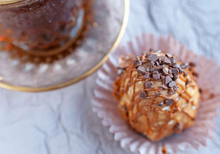 Top view of the cake from condensed milk and a glass cup of coffee on the table. Close up image