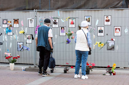 Saint-Petersburg, Russia â June 13, 2020: Woman and man look at the photos of the doctors and the medical workers who died from covid-19 in St Petersburg and Leningrad Region. Spontaneous memorialのeditorial素材